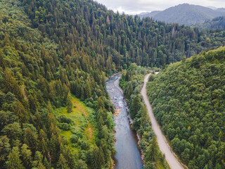 Fototapeta na wymiar aerial view of mountain river people rafting in creek