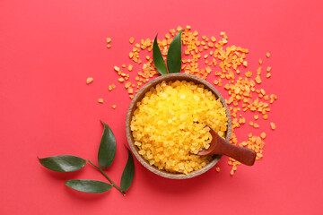 Bowl of orange sea salt on red background