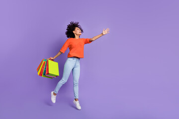 Full size photo of brown haired girl go shopping see huge bargains look empty space isolated on violet color background