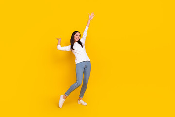 Fototapeta na wymiar Full size photo of young cheerful woman have fun hang-out look empty space isolated over yellow color background