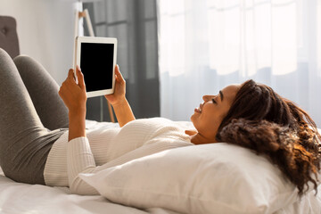 African American female holding tablet with blank empty screen