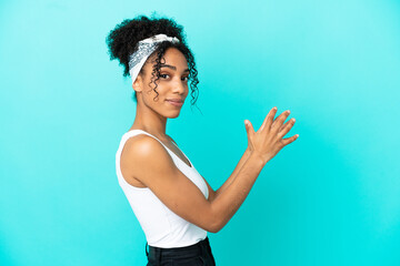 Young latin woman isolated on blue background scheming something