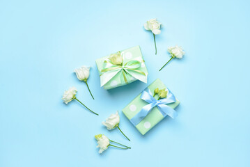 Composition with gift boxes and eustoma flowers on color background. International Women's Day celebration