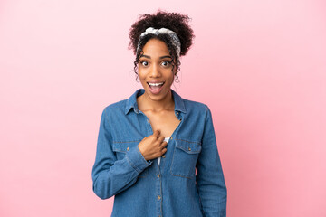 Young latin woman isolated on pink background with surprise facial expression