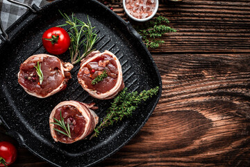 Raw fresh marbled meat Steak filet mignon. medallion steaks wrapped in bacon served on old meat butcher, Culinary, cooking concept. top view. place for text