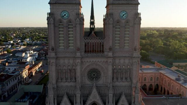 Basilica of Our Lady of Luj&aacute;n - Front Exterior Of Lujan Basilica With Clock Towers In Buenos Aires, Argentina. - aerial ascend