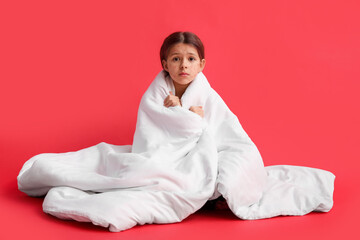 Little girl ill with chickenpox on red background