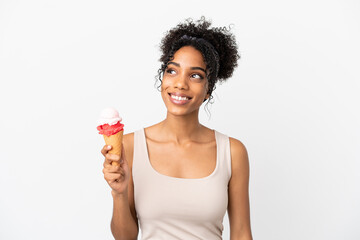Young african american woman with a cornet ice cream isolated on white background thinking an idea...