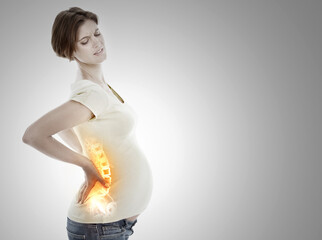 Facing the discomfort of pregnancy. A cropped view of a pregnant woman holding her lower back in...