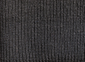  Fragment of a black woolen cloth knitted with an English ribbing pattern     
