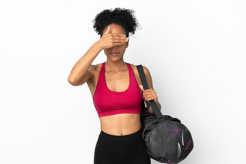 Fototapeta na wymiar Young sport african american woman with sport bag isolated on blue background covering eyes by hands. Do not want to see something