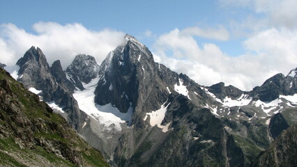 Mountain landscape in the Caucasus mountains with rocks and snow.