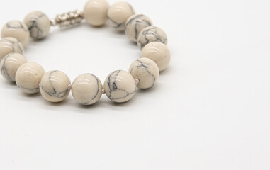 bracelet made of white natural stone on a white background