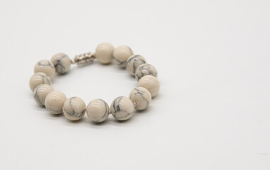 bracelet made of white natural stone on a white background