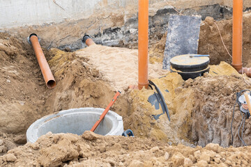 New Sewer Line developing work and mounting on the construction site in Israel. Orange PVC plastic...