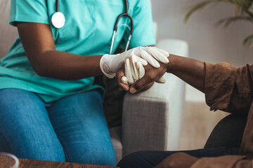 Nurse holding hand of senior man in rest home. Doctor helping old patient with Alzheimer's disease. Shot of a caregiver helping a senior man. Care Worker Helping Senior Man