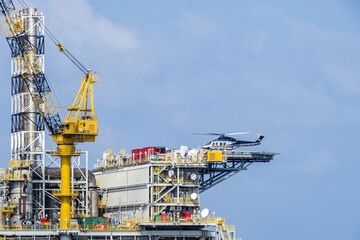 A helicopter landed on an oil production platform for transferring of offshore crew at oil field