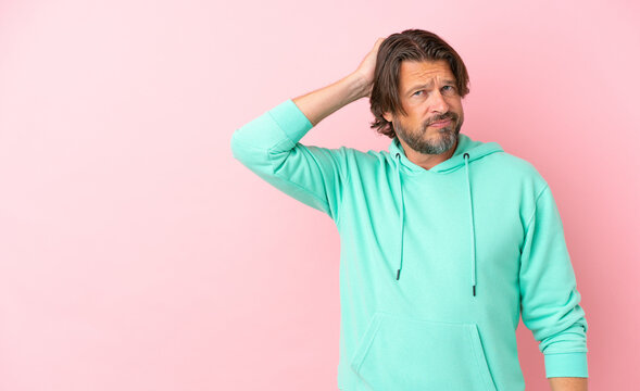 Senior dutch man isolated on pink background with an expression of frustration and not understanding