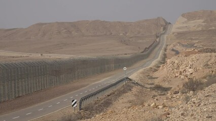 High security fence and heavily protected border between Israel's Negev desert and Egypt's Sinai, seen from the Israeli side.
