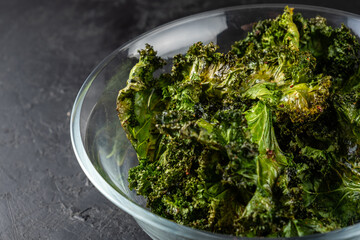 Close-up of kale chips in a glass bowl.