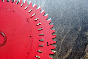 Two red spare blades for circular saw on wooden surface, furniture manufacturing, selective focus