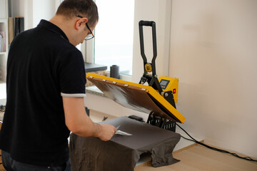 Man worker glasses back using heat thermal textile application transfer press. Printing technology...