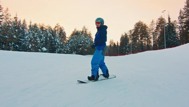 Young man snowboarding in the park