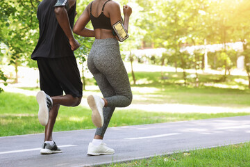 Active Lifestyle. Unrecognizable Black Couple Running Together In Morning Park, Rear View