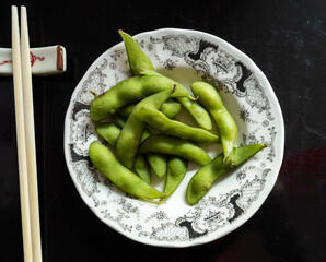 Concept: Asian healthy food. Edamame plate on the table.