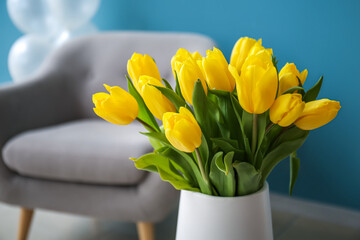 Vase with tulips in room, closeup