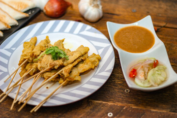 Pork satay - Grilled pork served with peanut sauce or sweet,sour sauce and toast,  Thai street food and delicious food in the restaurant.