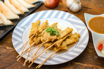 Pork satay - Grilled pork served with peanut sauce or sweet,sour sauce and toast,  Thai street food and delicious food in the restaurant.
