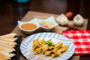 Pork satay - Grilled pork served with peanut sauce or sweet,sour sauce and toast,  Thai street food and delicious food in the restaurant.