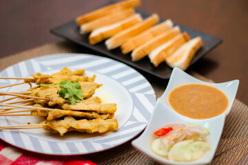 Pork satay - Grilled pork served with peanut sauce or sweet,sour sauce and toast,  Thai street food and delicious food in the restaurant.