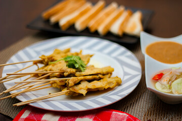 Pork satay - Grilled pork served with peanut sauce or sweet,sour sauce and toast,  Thai street food and delicious food in the restaurant.