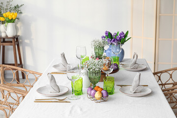 Beautiful table setting with flowers for Easter celebration