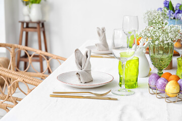 Plate with bunny made of napkin on dining table served for Easter celebration