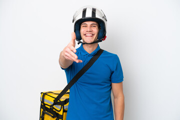 Young caucasian man with thermal backpack isolated on white background shaking hands for closing a good deal