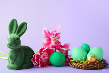 Cute Easter bunny with painted eggs and flowers on purple background