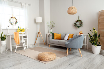 Interior of room with modern furniture and beautiful Easter decor