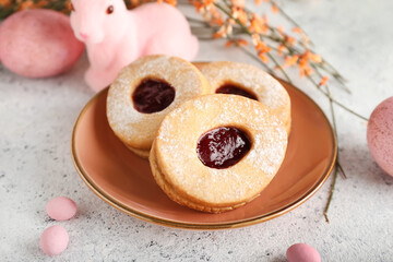 Plate with tasty Easter cookies on table, closeup