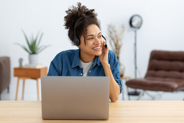 Portrait of happy African American female employee customer support services in headset, online consultation. Woman call center. Female customer support or sales agen