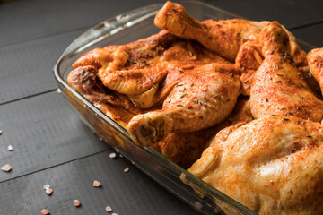 Chicken quarters with spices prepared for roast