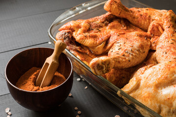 Chicken quarters with spices prepared for roast