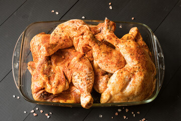Chicken quarters with spices prepared for roast