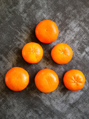 Close-up to fresh tangerine fruit on dark background