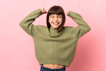 Little girl isolated on pink background doing strong gesture