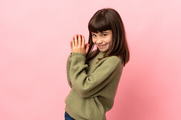 Little girl isolated on pink background scheming something