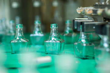 Bottles with a drink closed with a screw cap. Factory for the production of alcoholic beverages