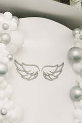 Beautiful white photo zone with balloons and angel wings